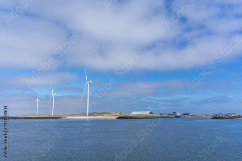 wind turbines on the coast of western Denmark under a blue sky