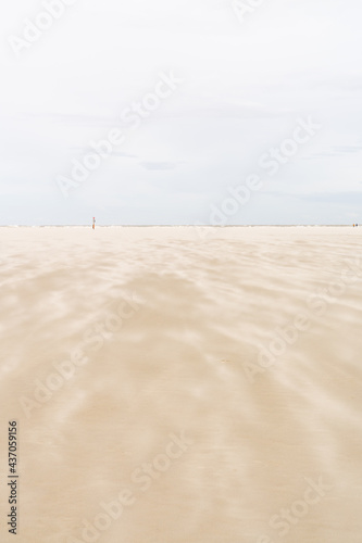 beautiful idyllic beach with a strong wind whipping sand along