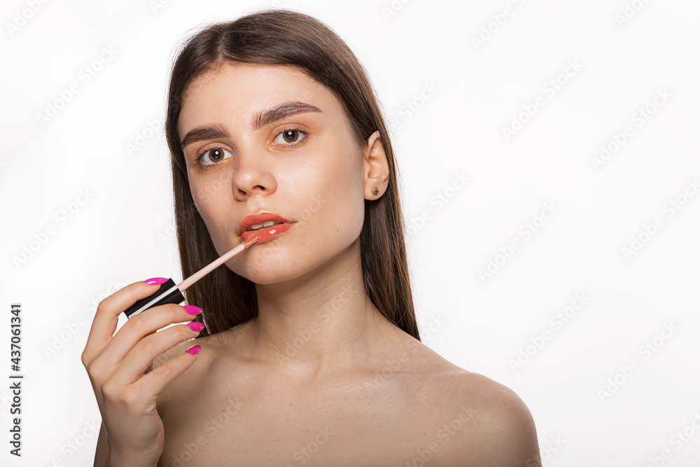 Beautiful woman face, sexy lips applying lip balm, lipcare stick on. Portrait of female model with natural makeup. Lips skin care and protection cosmetics concept. Beautiful woman face, sexy lips applying lip balm, lipcare stick on. Portrait of female model with natural makeup. Lips skin care and protection cosmetics concept.