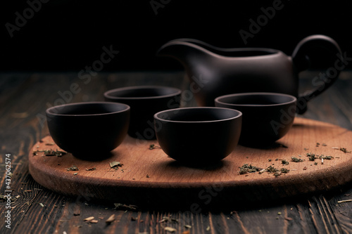 tea set and tea leaves on wooden kitchen board.