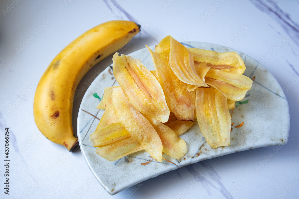 Banana Chips on a gray marble background Banana Chips on a gray marble background