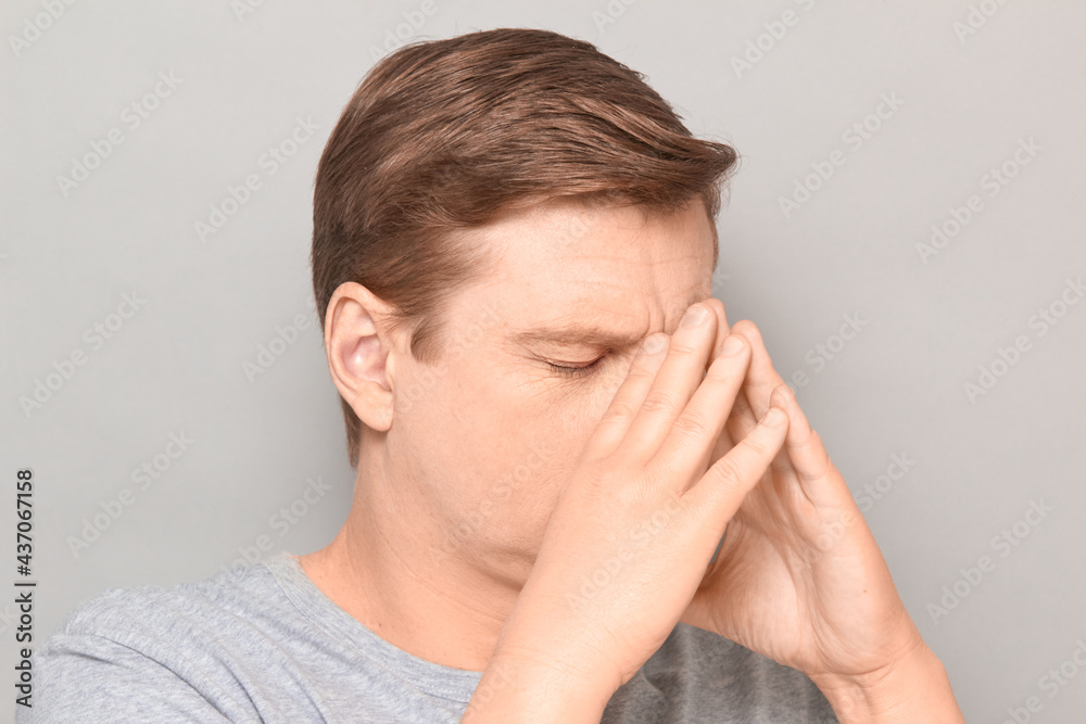 Portrait of mature man touching face with hands, trying to concentrate Portrait of mature man touching face with hands, trying to concentrate
