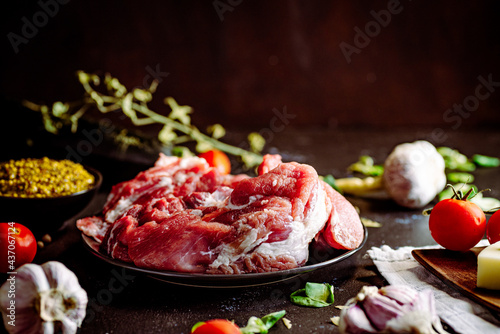 Fresh pork with vegetables on dark background. Fresh meat kitchen