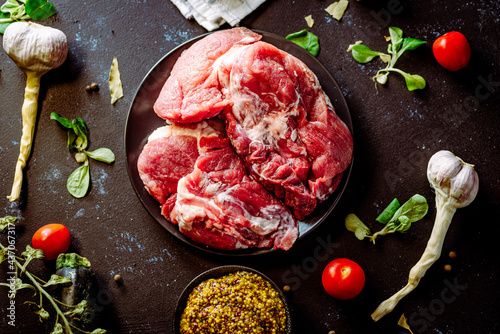 Fresh pork with vegetables on dark background. Fresh meat kitchen
