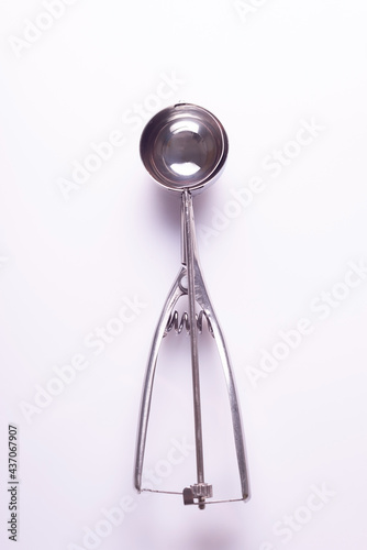 metal spoon for ice cream to form balls on a white background