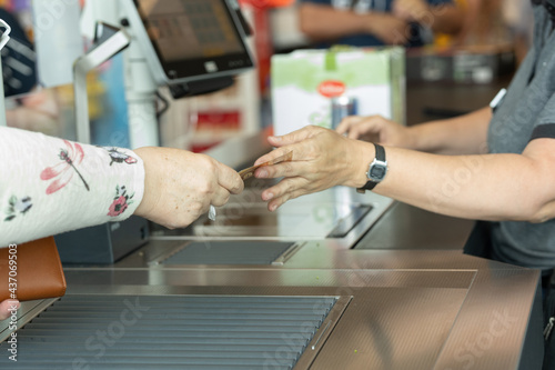 Customer paying the cashier at the supermarket.