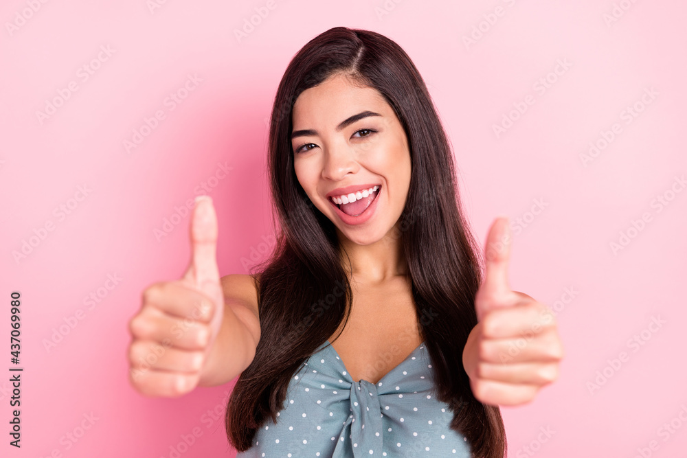Portrait of attractive cheerful woman showing giving two double thumbup isolated over pink pastel color background Portrait of attractive cheerful woman showing giving two double thumbup isolated over pink pastel color background