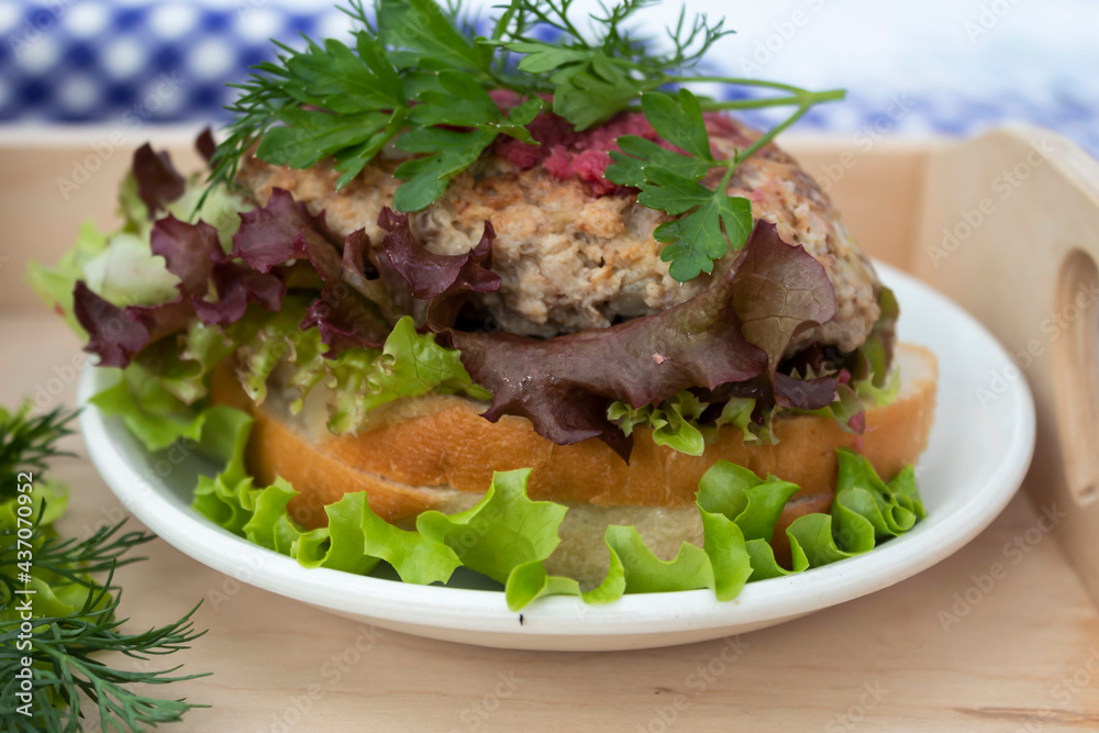 a sandwich with salad and cutlet