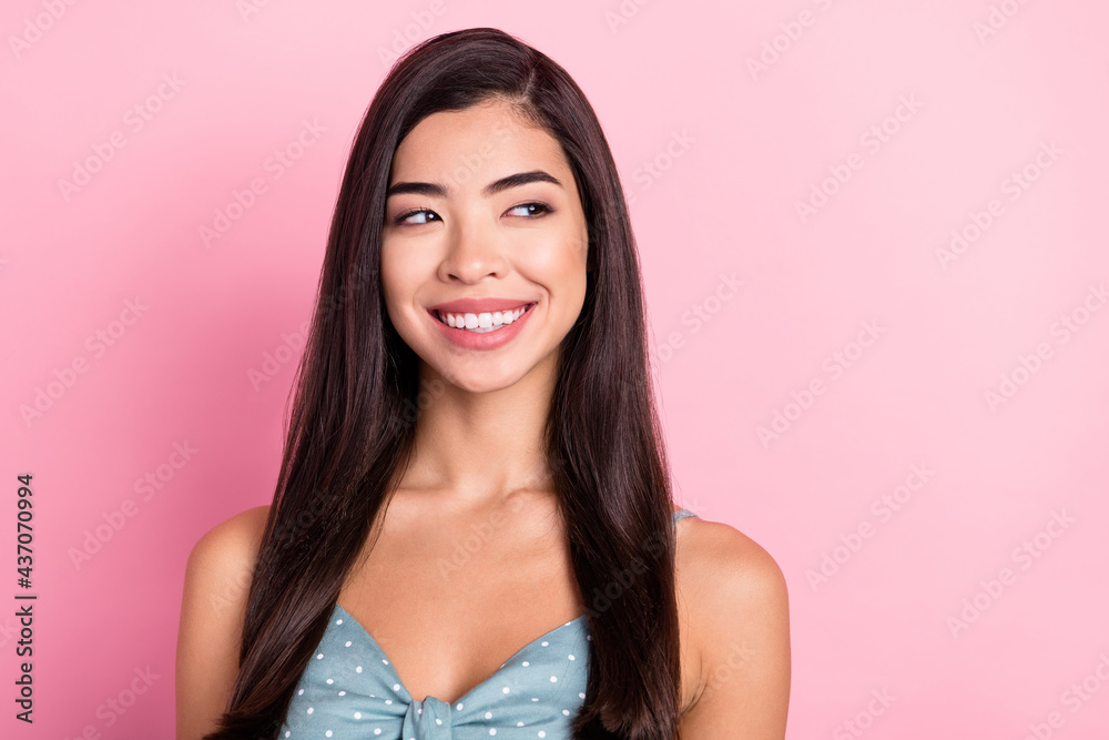Portrait of attractive cheerful long-haired woman looking aside copy empty space isolated over pink pastel color background Portrait of attractive cheerful long-haired woman looking aside copy empty space isolated over pink pastel color background