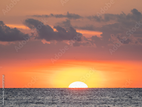 Sun in orange sky at sunset over the Gulf of Mexico off Venice, Florida USA © Jim Schwabel