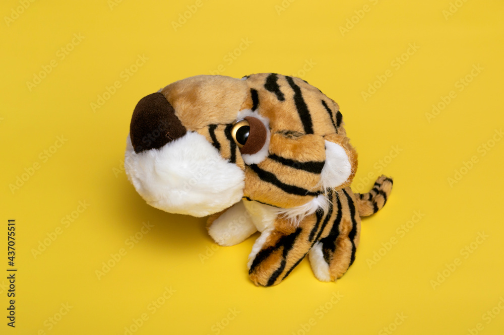 Obraz premium Close-up of a soft toy tiger. The tiger is a symbol of the next year 2022. The coming year of the tiger is 2022. Children's toy.