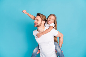 Portrait of handsome guy hold on back funky pupil piggyback look empty space isolated on blue color background
