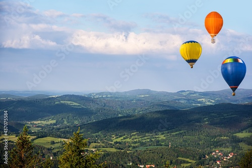 balloons fly beautifully, mountain landscape