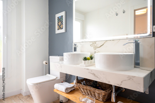 Interior of light modern bathroom with a mirror with light