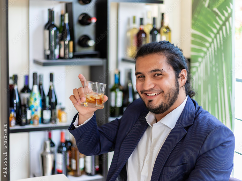 Hispanic businessman drinking mixed drink Hispanic businessman drinking mixed drink