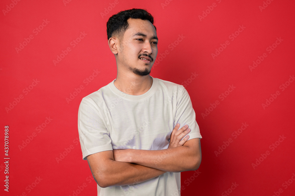 Young man with disgusted expression repulsing something. Disgust concept. Young emotional man. Human emotions, facial expression concept. Studio. Isolated on red color Young man with disgusted expression repulsing something. Disgust concept. Young emotional man. Human emotions, facial expression concept. Studio. Isolated on red color