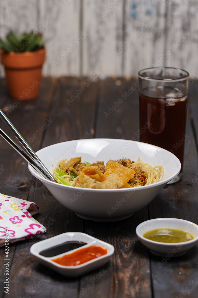 Indonesian food, mie ayam, noodles with chicken and served with meatballs