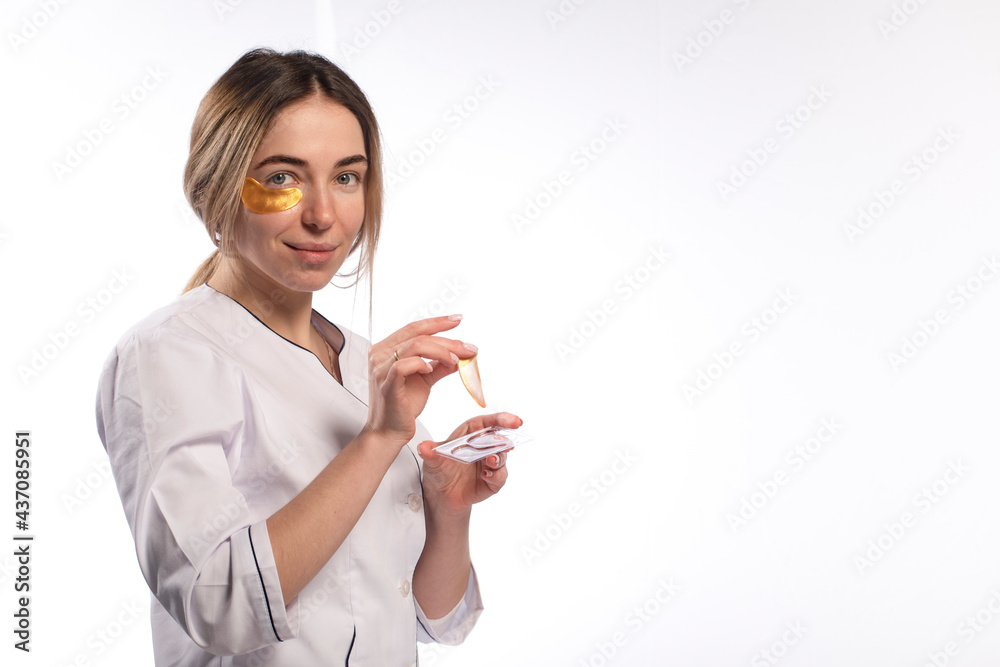 Eye patch on the face of a young woman on a light background. Eye patch on the face of a young woman on a light background.