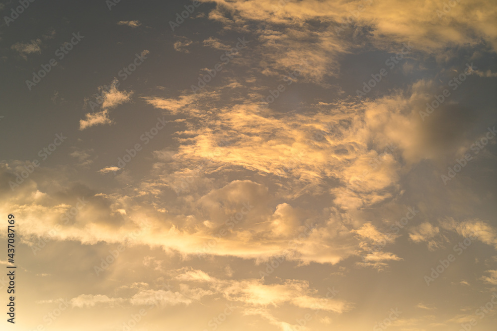 cloudy sky in dramatic orange sunlight during the sunset period. Nature, background and texture photo.