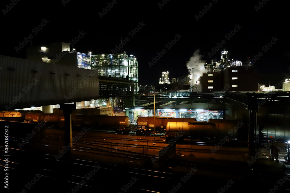 chemical factory with rail station at night chemical factory with rail station at night