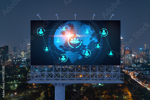 World planet Earth map hologram and social media icons on billboard over night panoramic city view of Bangkok, Southeast Asia. Networking and establishing new connections between people. Globe photo