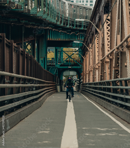 old bridge in the city man bike New York usa 