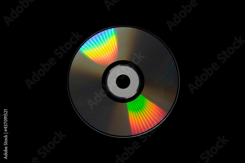 cd or dvd, storage data information technology. music and movie record. holographic side of the compact disc. a compact disc isolated on black background. photo