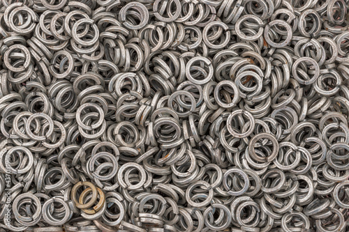 Steel grover washers for industrial manufacturing. Texture background of grover washers. photo