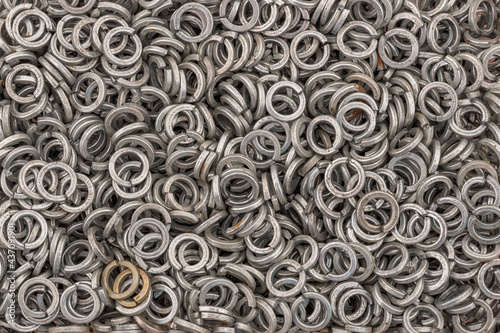 Steel grover washers for industrial manufacturing. Texture background of grover washers.