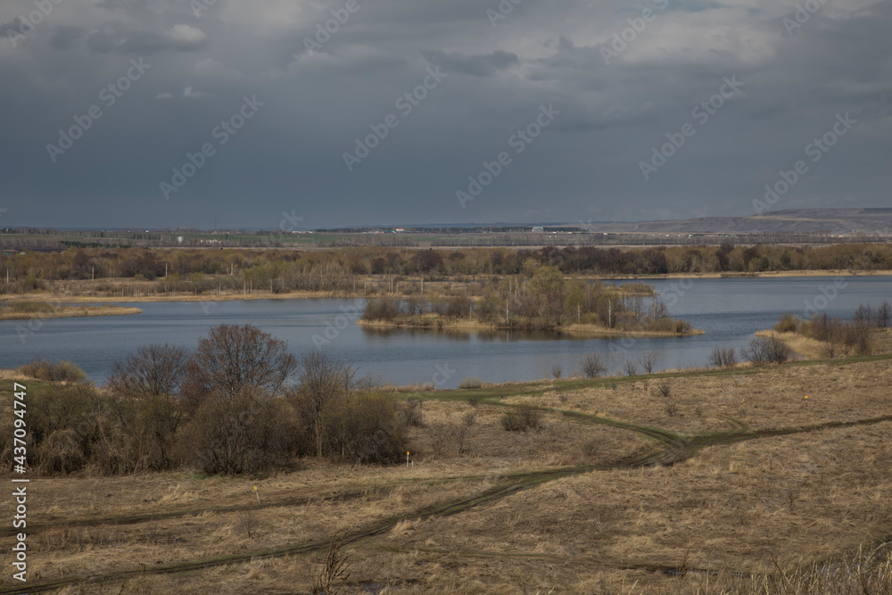 he beautiful nature of the southern Urals. Steppes and a lake in the distance. Sunny day. Blue sky. Beautiful landscape.	
