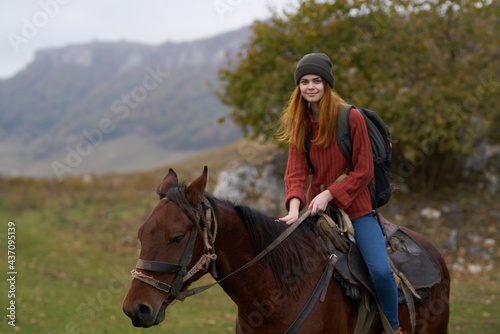 woman hiker mountains nature riding horse fun