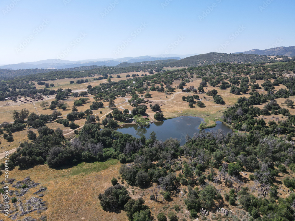 Aerial view of small lake in the valley, between farmland and forest in the town of Julian, east of San Diego, California, USA