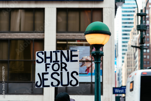 Banner with the text Shine for Jesus besides street lamp in New York City photo