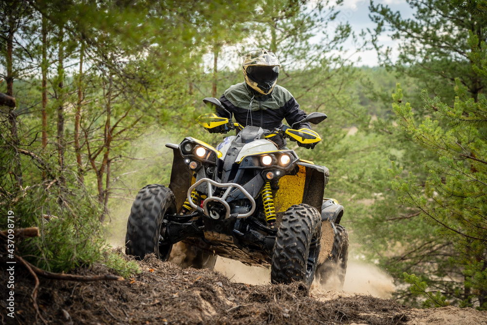 Fototapeta premium Professional quad biker rides in forest. Quad racing, ATV 4x4