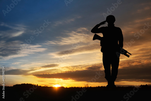 Silhouette of a soldiers against the sunrise. Concept - protection, patriotism, honor.