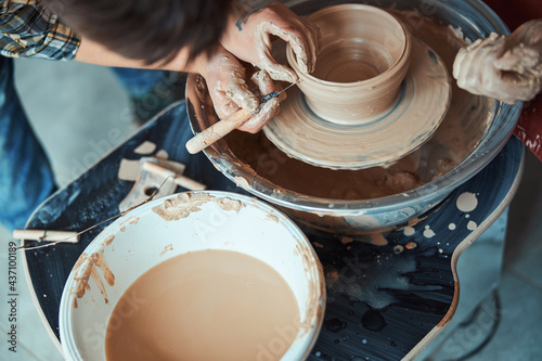 Female ceramist hands making pottery in workshop photo