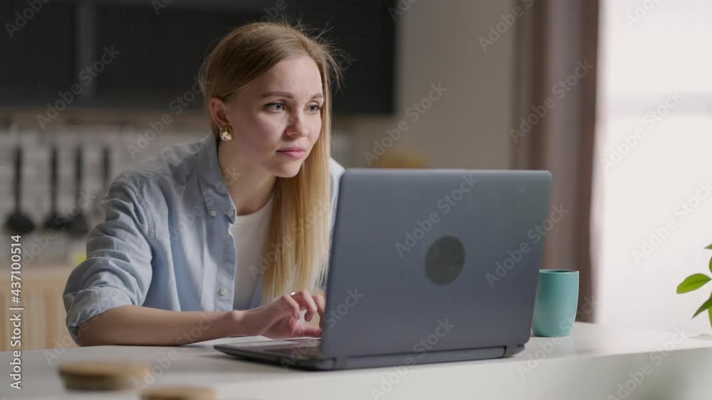 serious female student wear elearning study with online tutor teacher talk conference calling do video chat learn language make notes sit at home office desk look at laptop computer serious female student wear elearning study with online tutor teacher talk conference calling do video chat learn language make notes sit at home office desk look at laptop computer