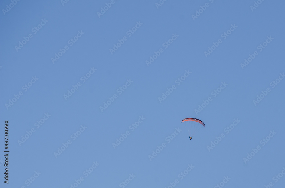 A paraglider in the blue sky, large image with fine detail and lots of copy space A paraglider in the blue sky, large image with fine detail and lots of copy space