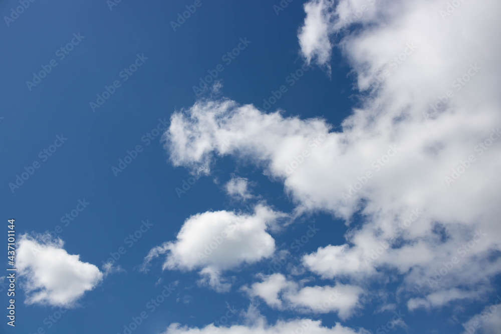 Beautiful sky background. Oddly shaped clouds in a blue sky Beautiful sky background. Oddly shaped clouds in a blue sky