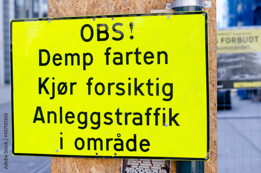 Traffic warning sign in Norwegian, advising to keep speed down for construction vehicles Traffic warning sign in Norwegian, advising to keep speed down for construction vehicles