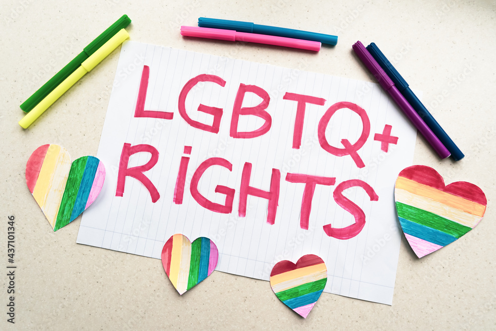 sheet of paper with the Lgbtq+ rights inscription lies on a table with ...