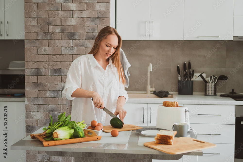Beautiful girl in the kitchen prepares healthy food Beautiful girl in the kitchen prepares healthy food