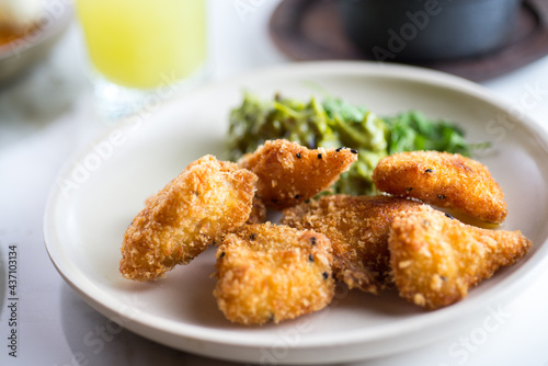 Chicken fingers in a dish placed in a table with other elements