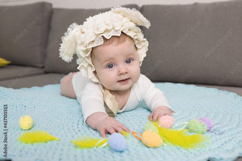 Happy adorable newborn baby in a rabbit costume. Eye contact. Lovely family memories, easter concept. Caucasian kid. Lifestyle. Horizontal. Happy adorable newborn baby in a rabbit costume. Eye contact. Lovely family memories, easter concept. Caucasian kid. Lifestyle. Horizontal.