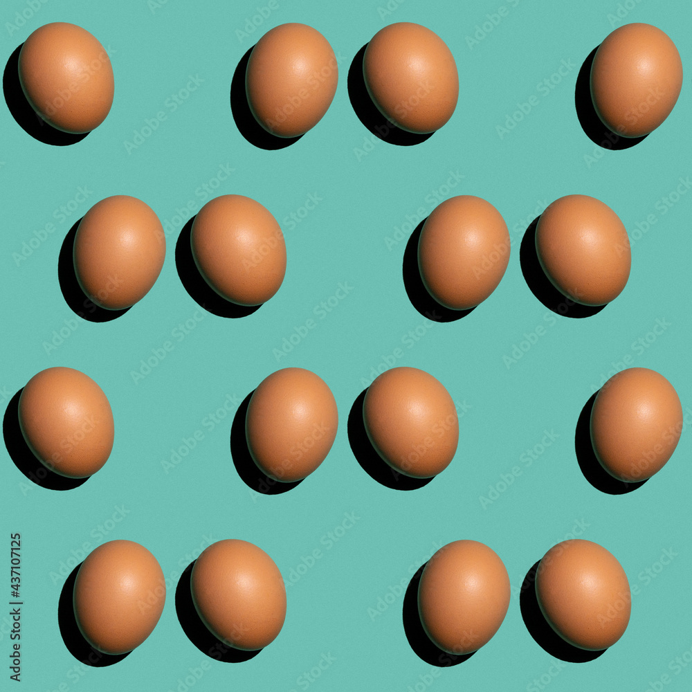 Seamless texture background pattern from eggs on a colored background. Minimal food concept. Seamless texture background pattern from eggs on a colored background. Minimal food concept.