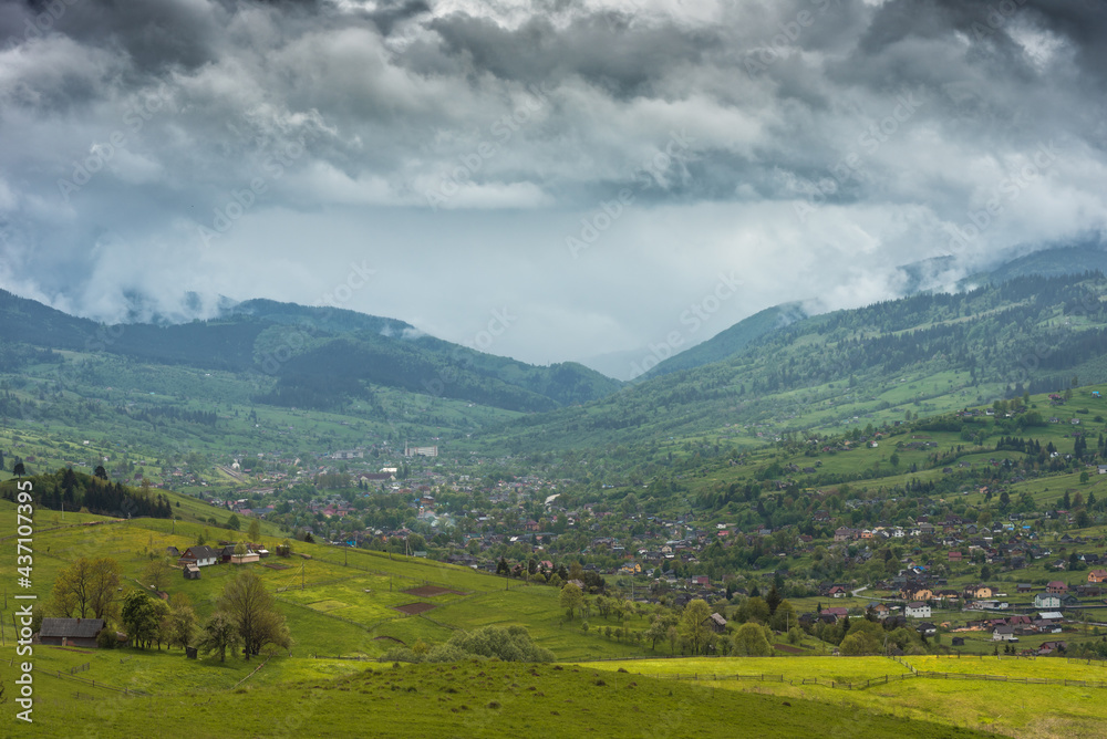 Low dramatic clouds over the mountain village