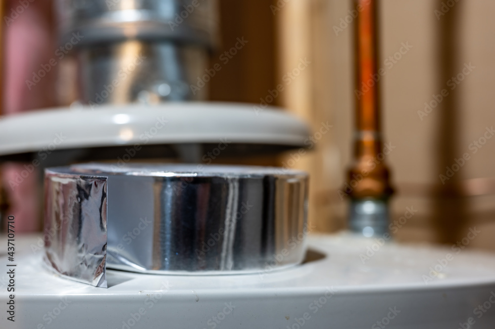 selective focus on the edge of a roll of metallic aluminum foil HVAC duct tape selective focus on the edge of a roll of metallic aluminum foil HVAC duct tape