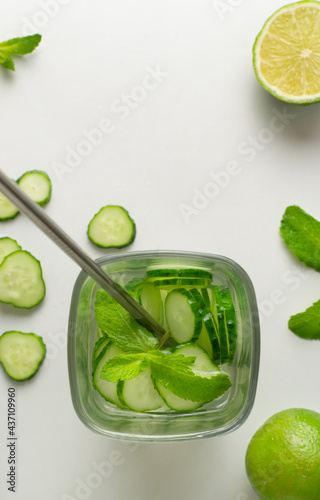 A glass of detox water infused with cucumber and mint, with ingredients. Health care, fitness, healthy food concept. Top view.