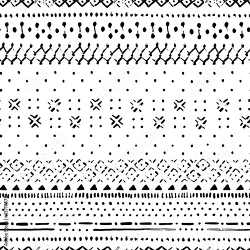 Hand drawn seamless pattern in bohemian style with old texture effect. Black and white boho stripes pattern with dots and brush strokes.