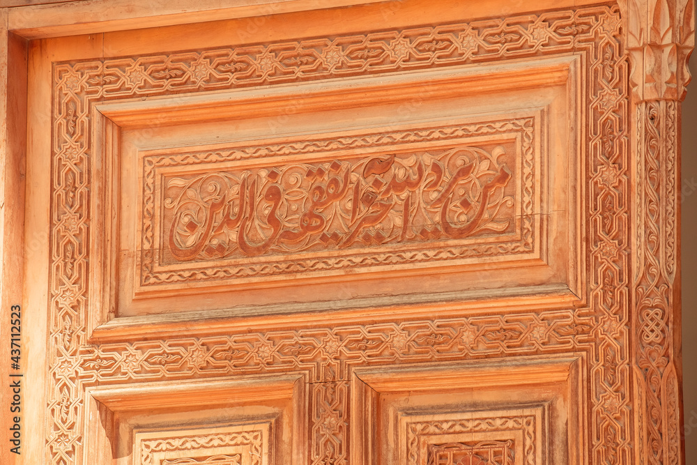 Obraz premium beautiful carved wooden doors with brass inserts and massive brass handles